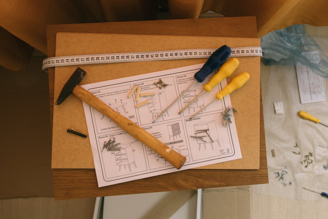 about-us Hammer, screwdrivers, and instructions for assembling furniture. Perfect for DIY enthusiasts.